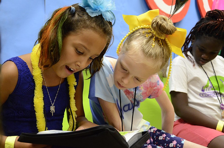 Aliviyah Moss and Abigail Jeter read scripture during 