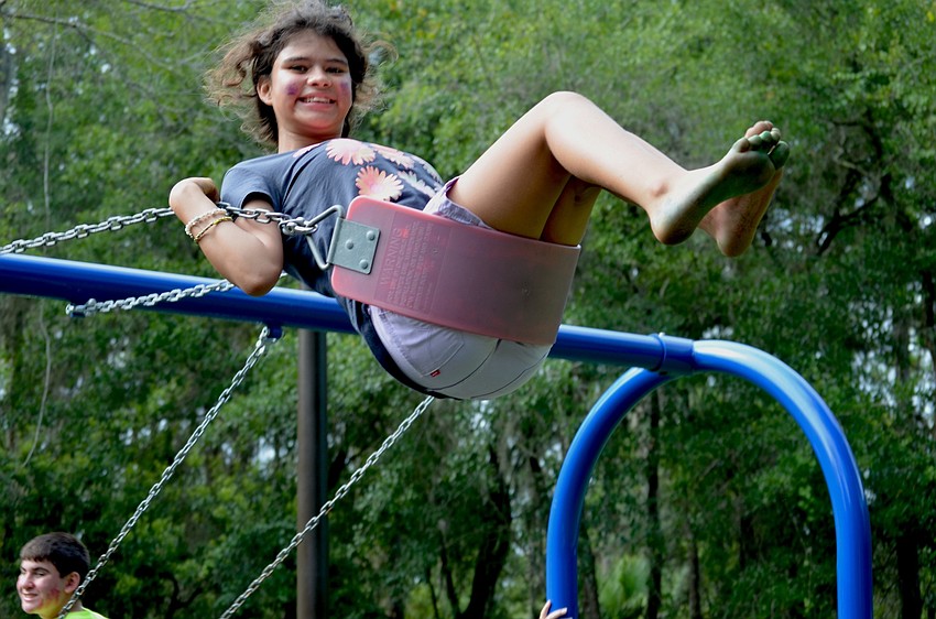 Twelve-year-old Anna Lawrence swings to new heights.