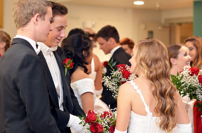 The 2014 debutantes and their escorts mingle in the foyer at the Sarasota Orchestra before heading into the Sarasota Municipal Auditorium ballroom for their debut.