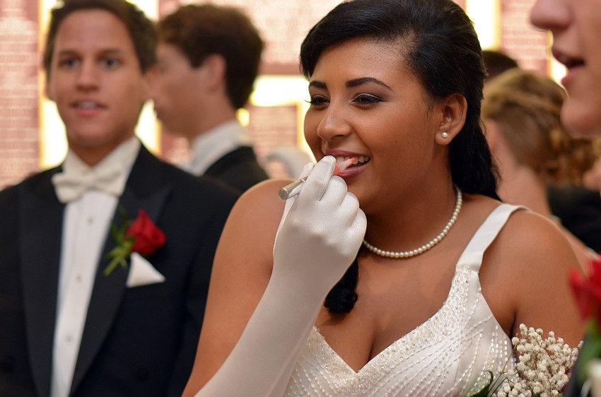 Sazlyn Qualls reapplies her lip gloss before The Debutante Ball.