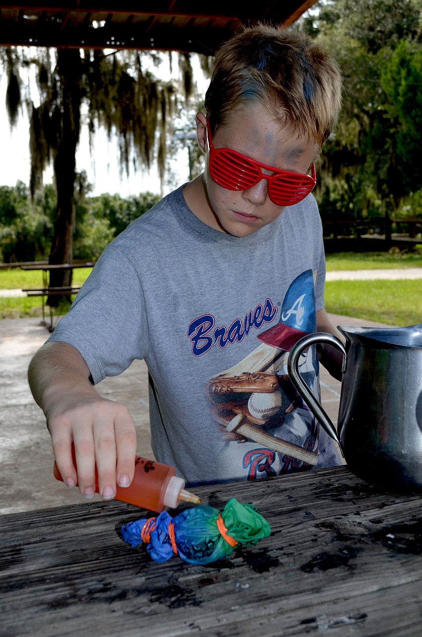 Jacob Micca focuses on his project, even through his sunglasses.