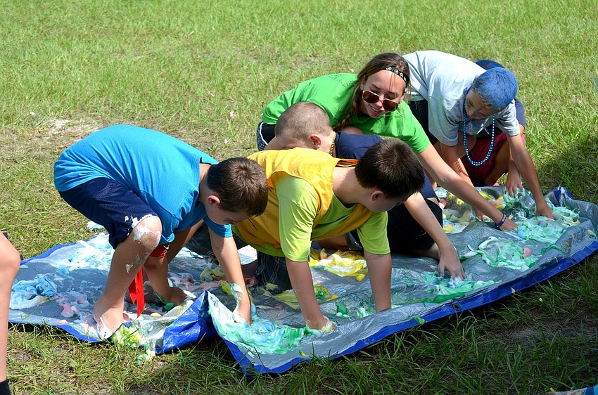 Campers and volunteers try a new — and messier — spin on Twister.