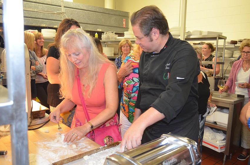 Chef Andrea Bozzolo, right, shows Carol Sher how to make gnocchi