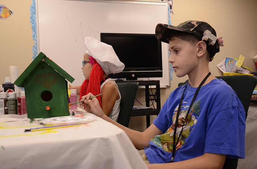 Tyler Filewich puts the finishing touches on his bird house.