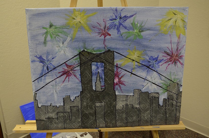 Students worked on a mixed-materials project for art class, using paint and Modge Podge glue to create a city (or beach) skyline on a painted canvas.