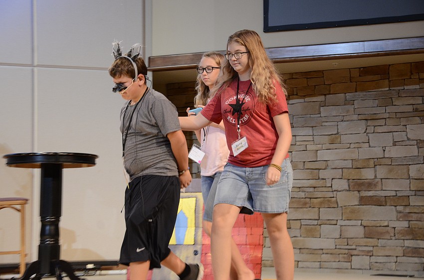 Michael Kasper, the wolf, is handcuffed and escorted away by Karla Bernard and Katie Butts, during a rehearsal in drama class.