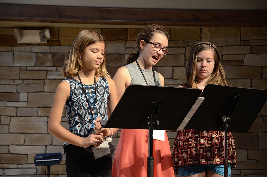 Lillian Torres, Melodie Dube and Jennifer Schillinger act as narrators for the drama class play.