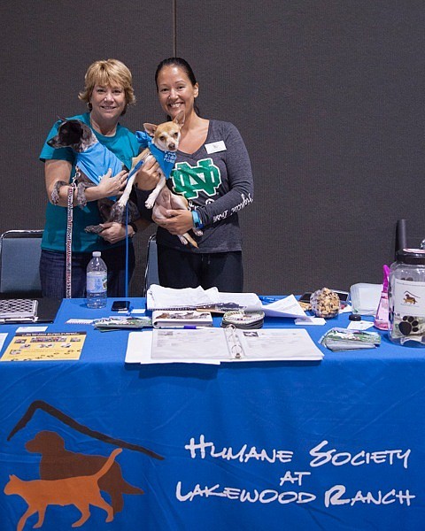 Cindy Skarda and Rebekah Boos are on hand to educate visitors about the Humane Soceity of Lakewood Ranch. Milo and Sawyer helped. Photo courtesy of Mindy Towns.