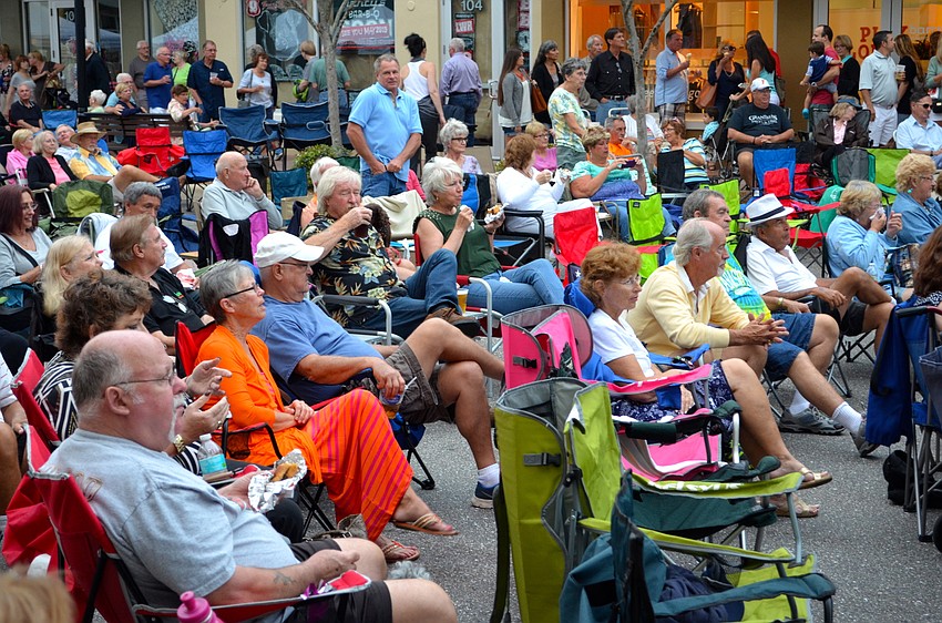 Attendees of the First Friday event enjoy free music by Melanie Massell & Hot Item.