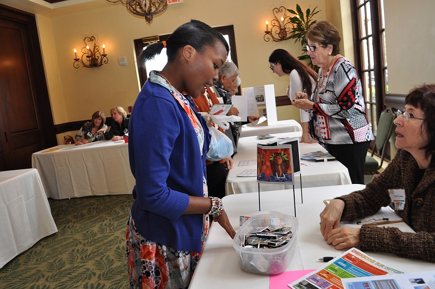 Maryline Mamuya, who is visiting from Tanzania, talks with Joan Lowery at the Embracing Our Differences booth.