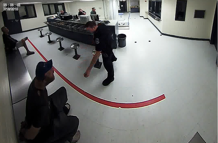 Video footage from the Sarasota County jail showed the officer repeatedly throwing food at a handcuffed individual.