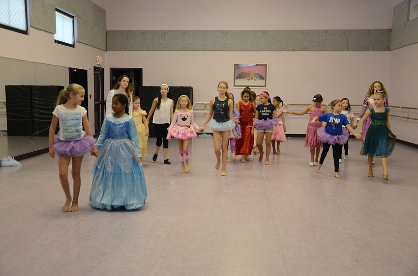 Danielle Kirchberg, 10, far left, and partner Neiplei Rousan, 7, far right, lead the procession.