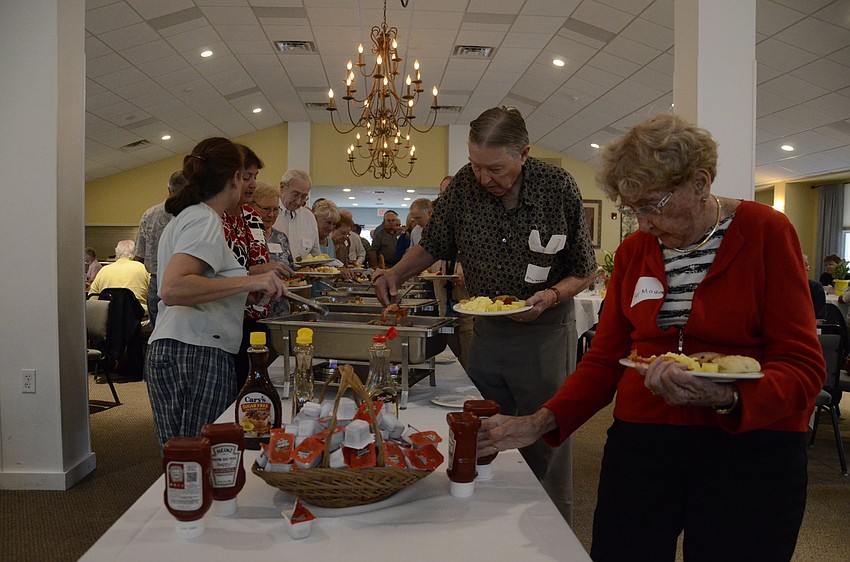 Siesta Key Association members fill their plates with breakfast favorites at the annual meeting.
