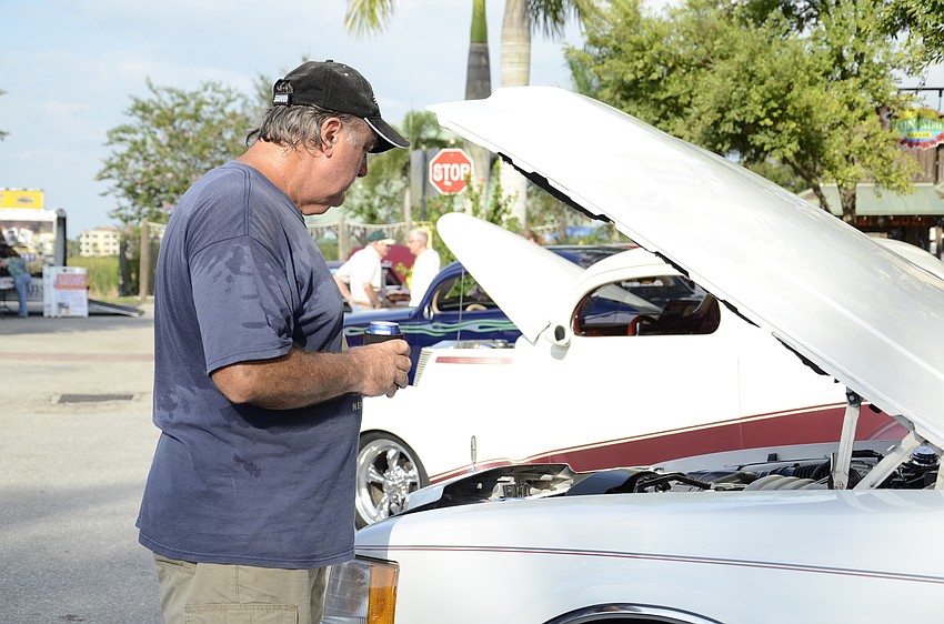 Pat Wynn examines his original 1991 Lincoln Mark VII. His father worked for Lincoln Mercury, which attracted him to the car.