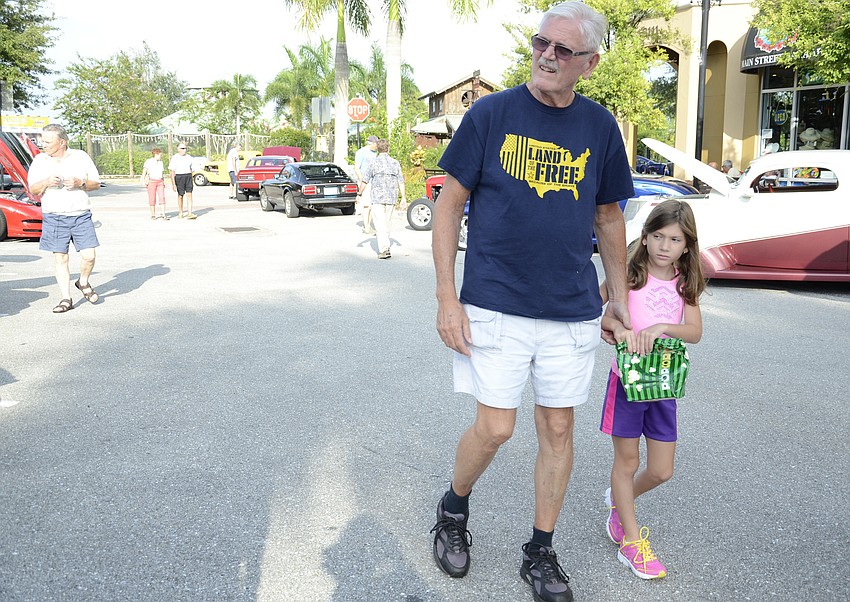 Ron Kutch and granddaughter Natalia, 8, check out the models after seeing a movie together with grandmother Sandy.