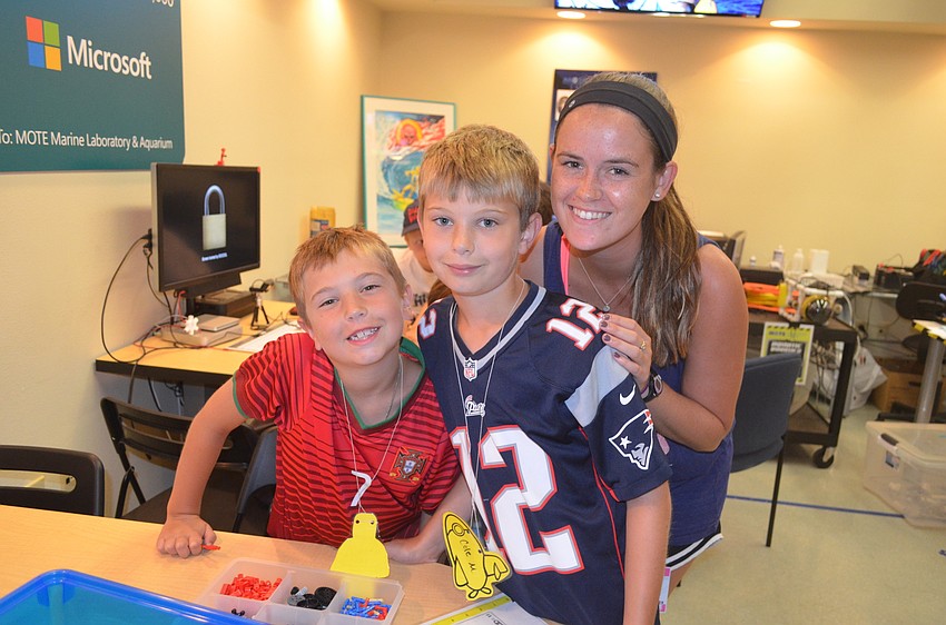 Logan and Cole Matthews, 7 and 9, with education intern Lauren Beames