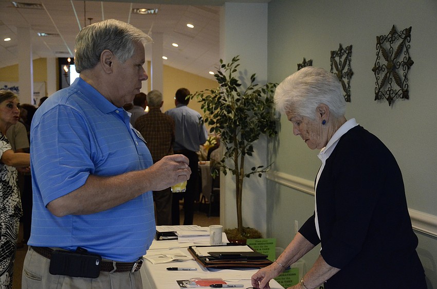 Board member Paul Wilkinson talks with Helen Clifford, SKA's treasurer.