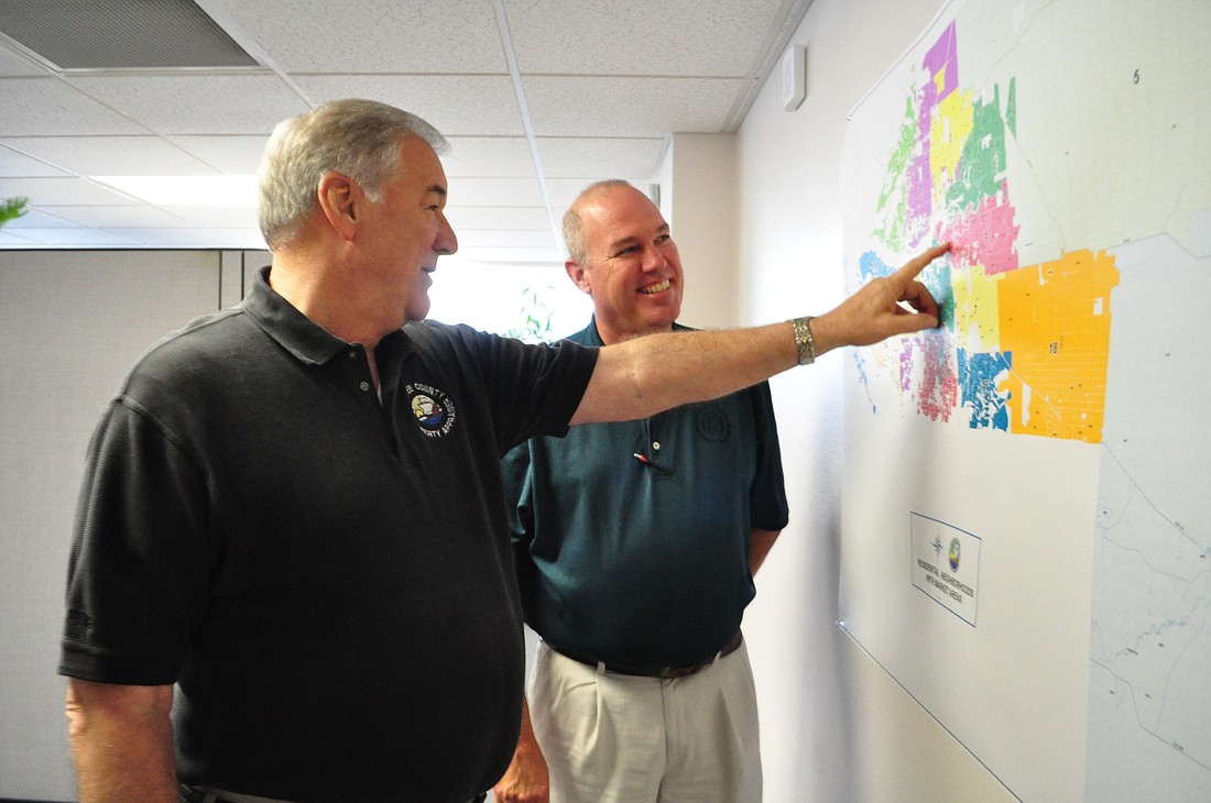 Manatee County Property Appraiser Charles Hackney and Director of Appraisal Services Mark Johns look at a map that shows the county's market areas.
