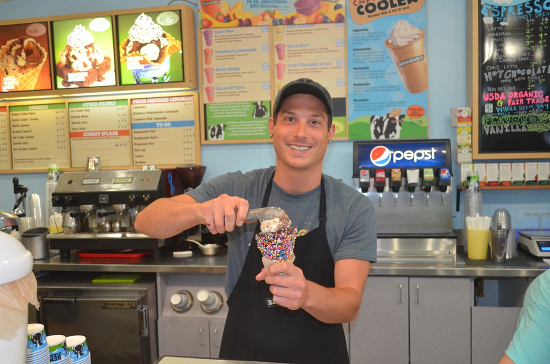 Ben & Jerryâ€™s Manager Peter Quaresima scoops The Tonight Dough, one of the shopâ€™s most popular flavors.