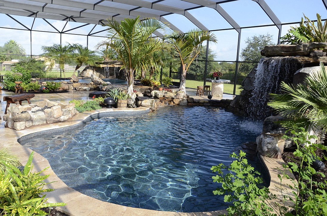 The Taylor's personal oasis is a natural double-pool set up with a "creek" connecting the two bodies of water.
