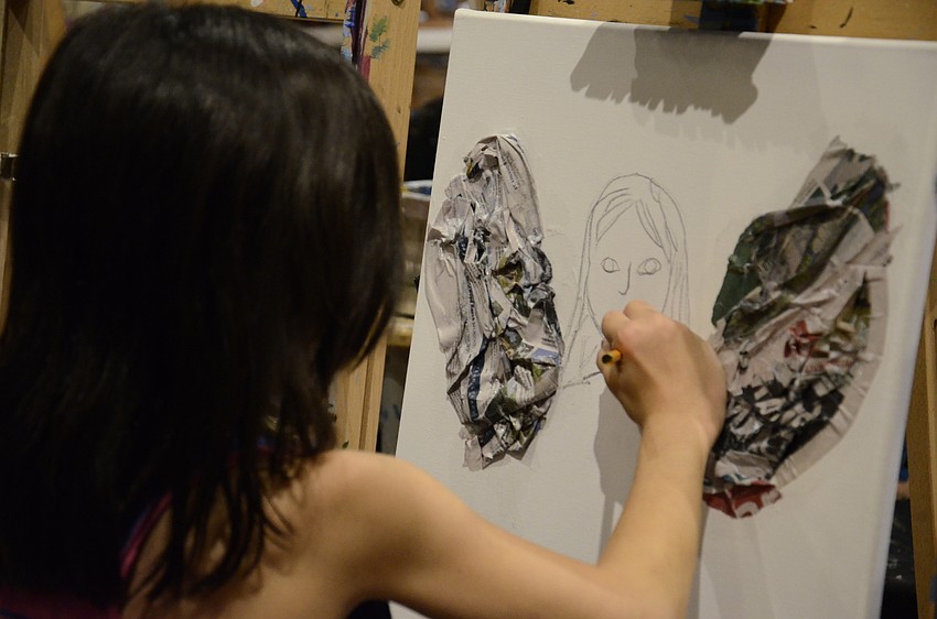 Valentina Alvarez draws a face on her fairy.