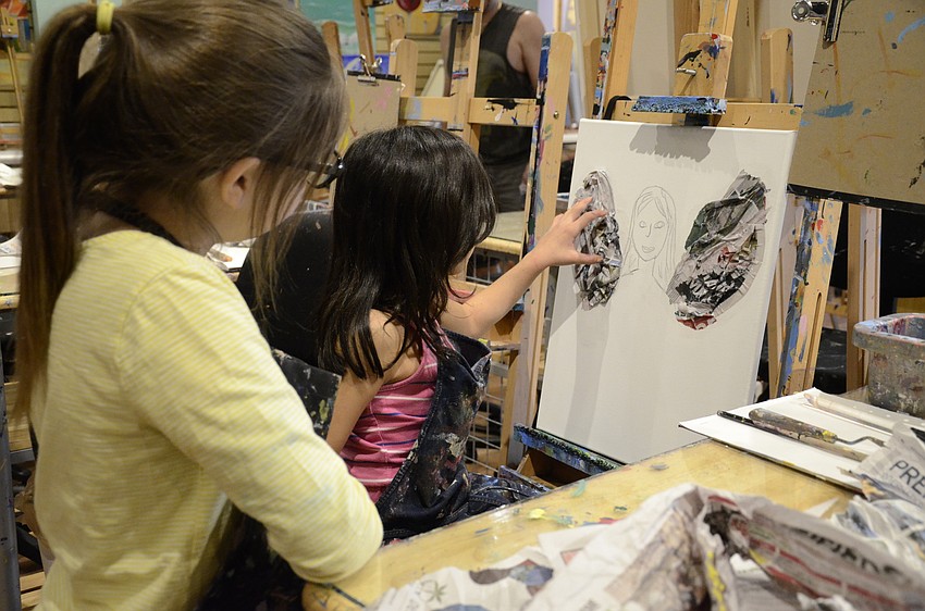 Valentina Alvarez, right, talks with Olivia Sherry, left, about her fairy art project.