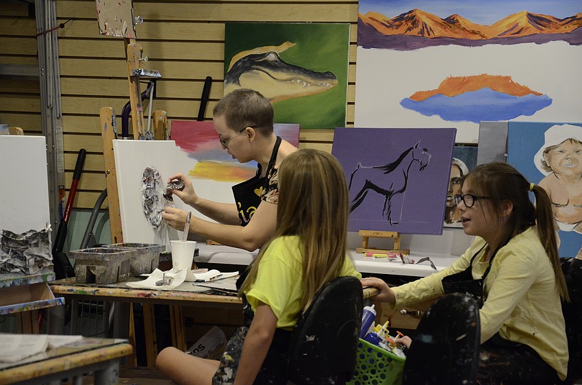 Asia Akhmetova helps Marissa Vieth and Olivia Sherry.