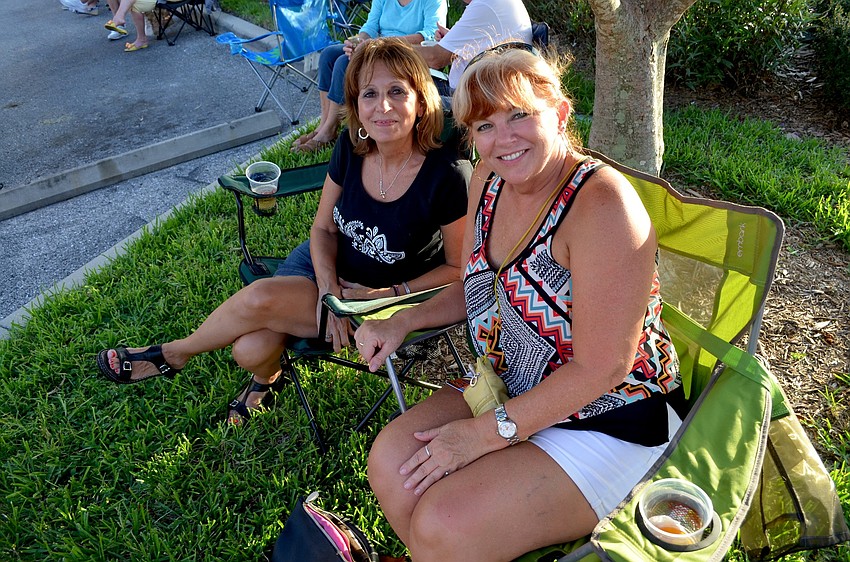 Bridgette Stacy and Vicki Williams enjoy live music from the lawn.