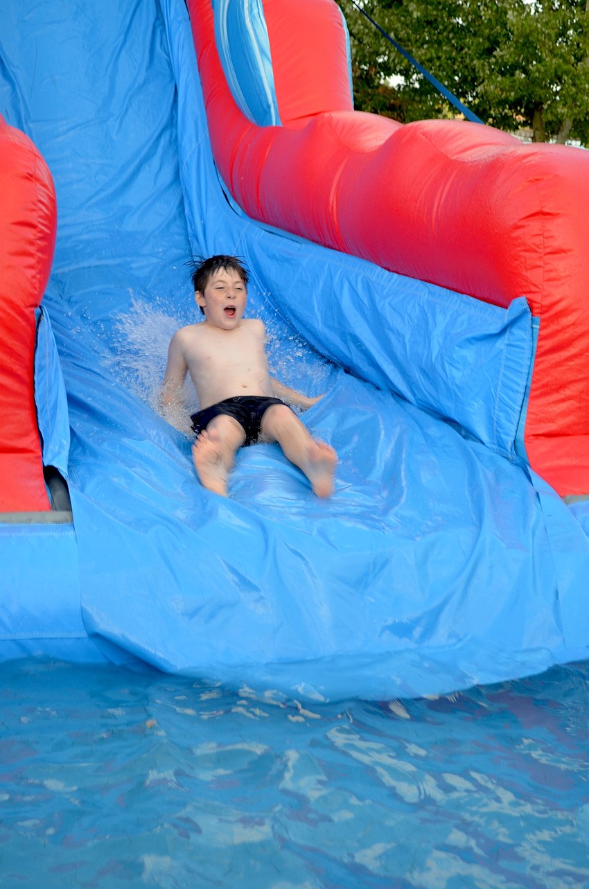 Joey Cane speeds down a giant water slide.