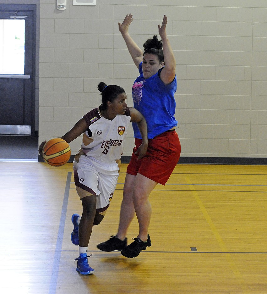 Venezuela’s Yosimar Corrales attempts to maneuver past Sarasota Rec League’s Kristen Walding.