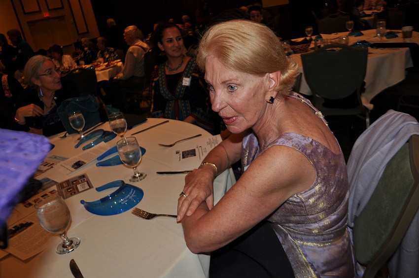 Lois Schaper, wearing clothing from Pakistan, chats with new friends.