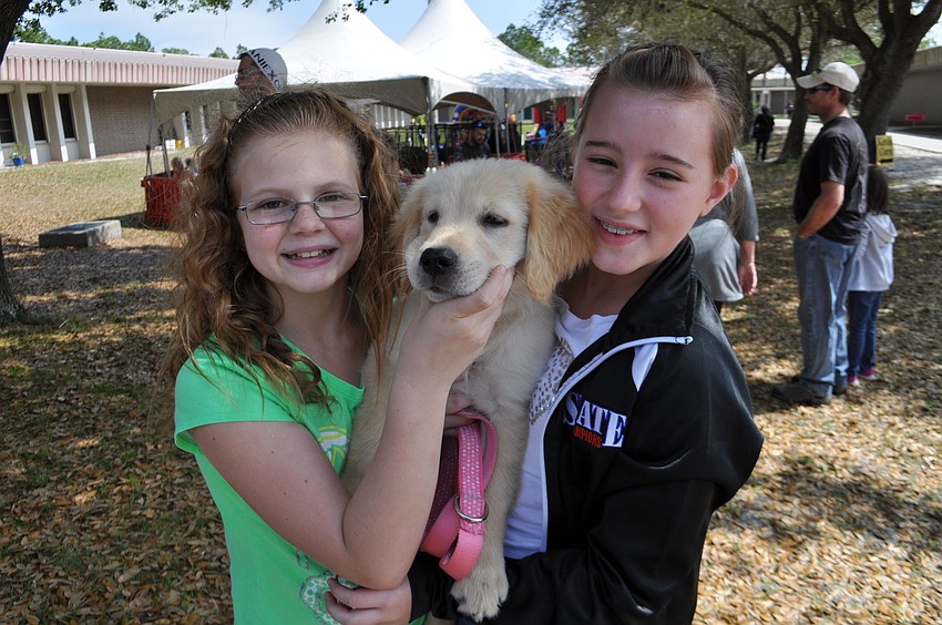 Katie Sloat hangs out with Amber Parsons and Amber’s new puppy, Trigger.