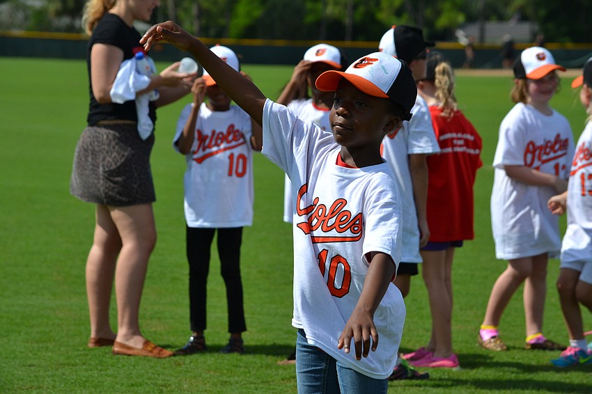 Janiyah Goodman launches the baseball.