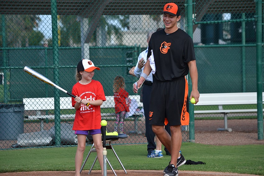 Skylar Stone takes batting tips from Tristan Graham.