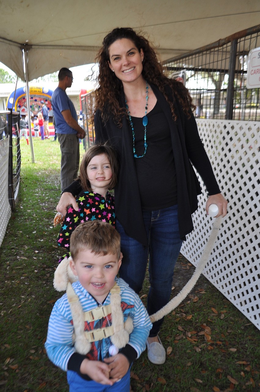 Tracy Lightburne brings her children, Gracie and Mitch, through the petting zoo.