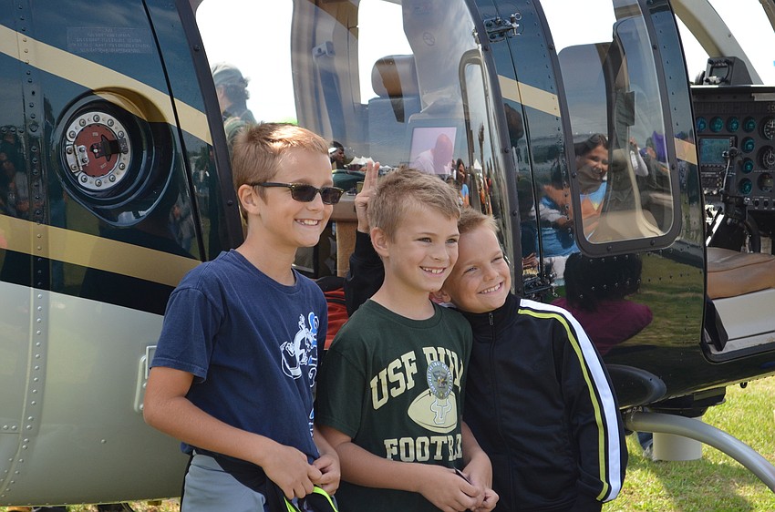 Friends Caleb Hespe, Isaac Francis and Zachary Hespe pose in front of the Sarasota County Sheriff’s Office helicopter.