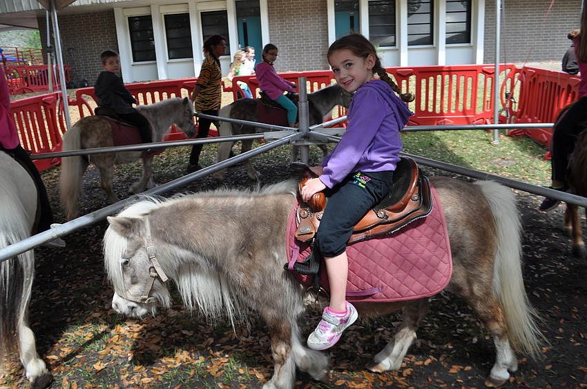 Cristina Springfield, 4, enjoys her pony ride so much she wants to go again.