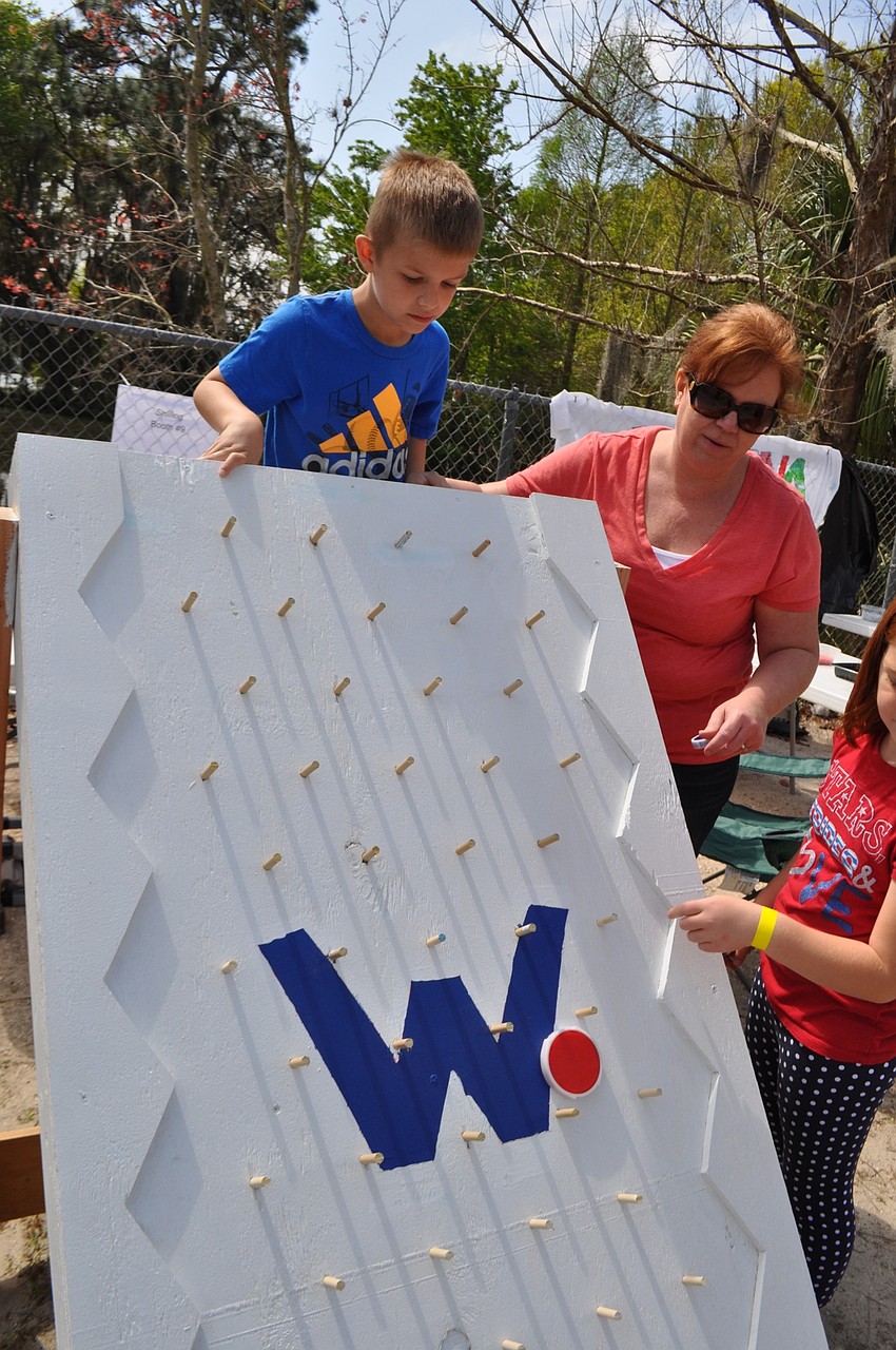 Kaden Greer, 7, wins the big prize after completing a game of Plinko.