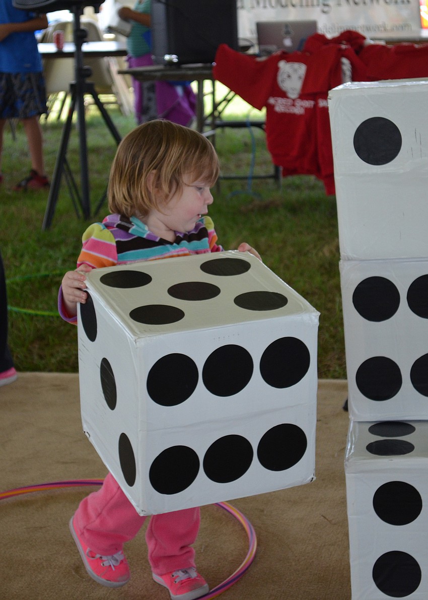 Reagan Foley stacks dice.