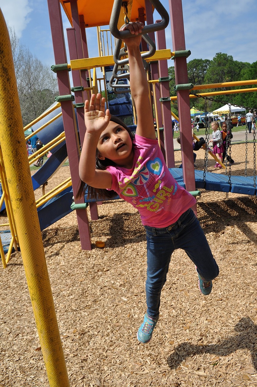 Aryanna Parrish is a pro at the monkey bars.