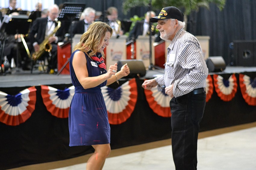 Goodwill Manasota Director of American Veterans and Their Families initiative and veteran herself C.J. Bannister dances with Buck Best.
