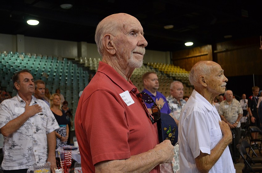 Hugh Fleming holds his hat over his heart for the 