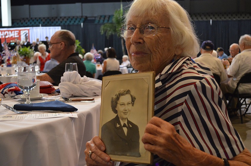 Jean White holds a photo of her taken while she served in the Navy during WWII.