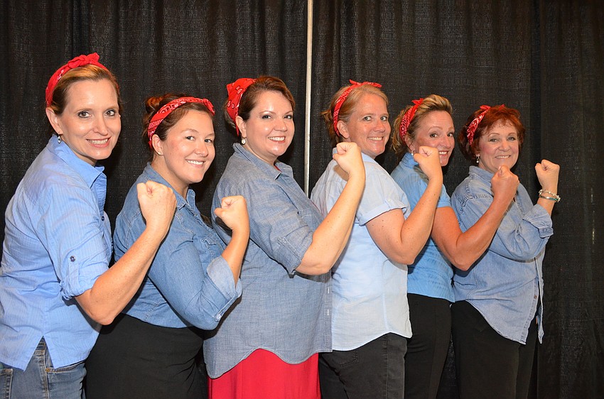 Kathy Jordan, Kelly Davis, Goodwill Manasota Foundation Vice President Veronica Brandon Miller, Lou Ann Linn, Kelly Gardner and Mary LeMay all dressed as Rosie the Riveter.