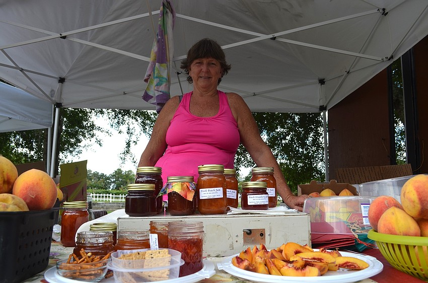 Beth Hill, of the Peach Lady's Stand, offers peach jam, whole peaches and other items flavored with the fruit.