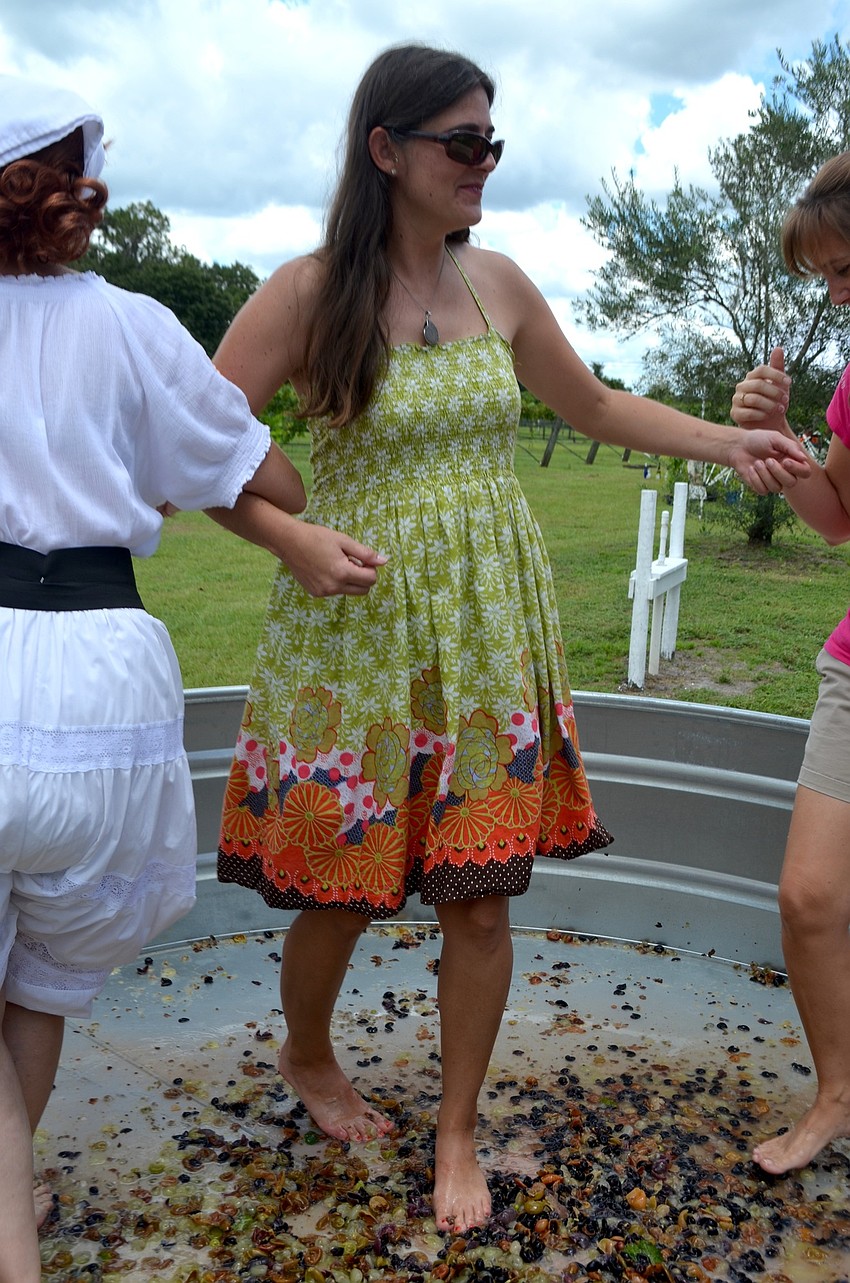 Rachel Forsyth dances and spins around on a floor made of grapes.
