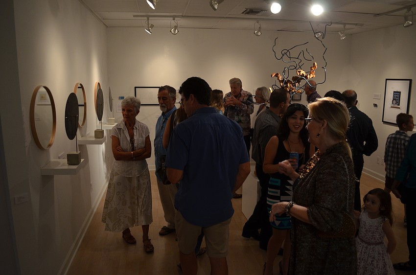 Families, friends and art lovers examining the diverse spread of works by the SARTQ collective.