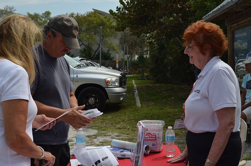 Dana Burnett from the Sarasota chapter of the American Red Cross speaks with guests.