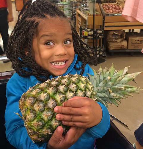 Jaliyah Campbell helped her mother out during a Cooking Matters class that took the group grocery shopping.