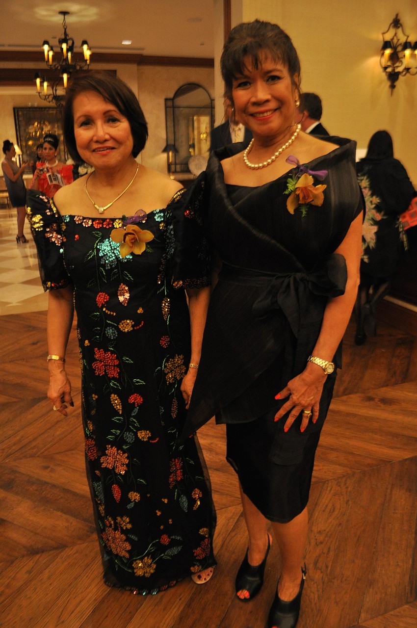 Asian Women’s Club President Maria Cora Gaffar and Vice President Cora Sanders greet guests.